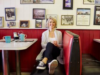 Samantha Brown sitting at The Swiss Kitchen, Tupper Lake, NY. As seen on Travel Channel's 50/50. 
